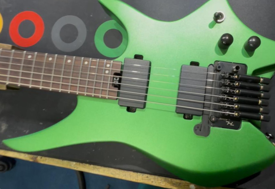 Green custom electric guitar on the workbench